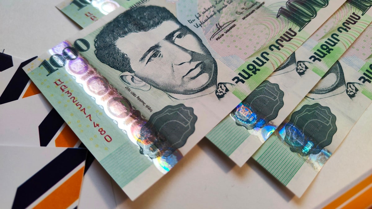 Armenian money paper banknotes AMD dram on the table. Composition closeup shot of paper banknotes from above